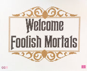 needlepoint canvas featuring the phrase "Welcome foolish mortals"
