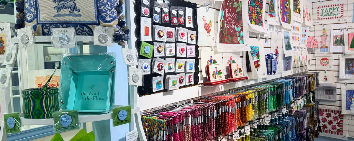needlepoint store with needle minders accessories and needlepoint canvases on display