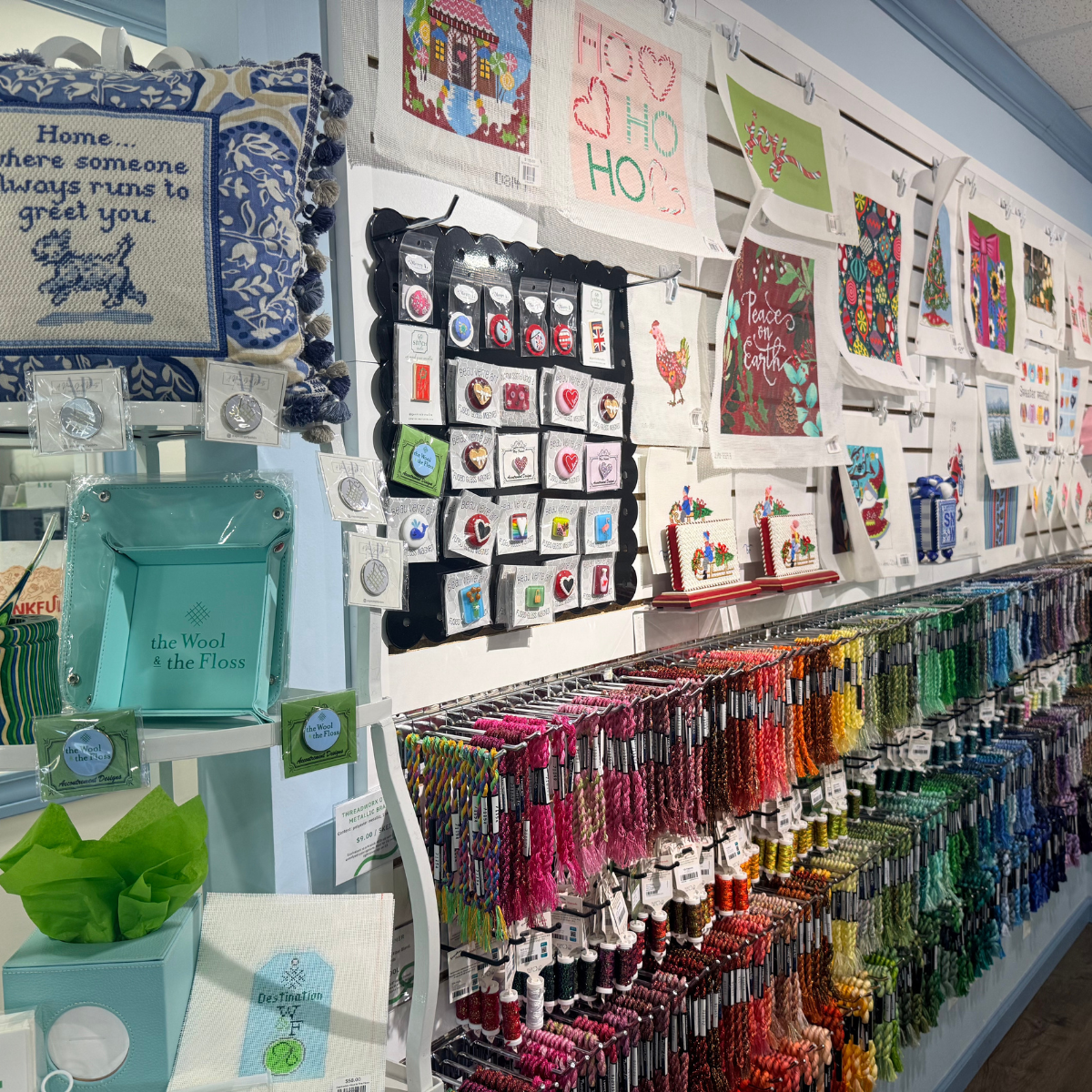 needlepoint store with needle minders accessories and needlepoint canvases on display